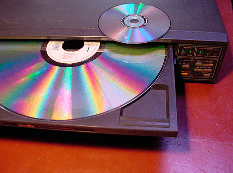 Laserdisc player with DVD media on top